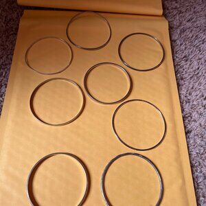 8 Silver toned bracelets